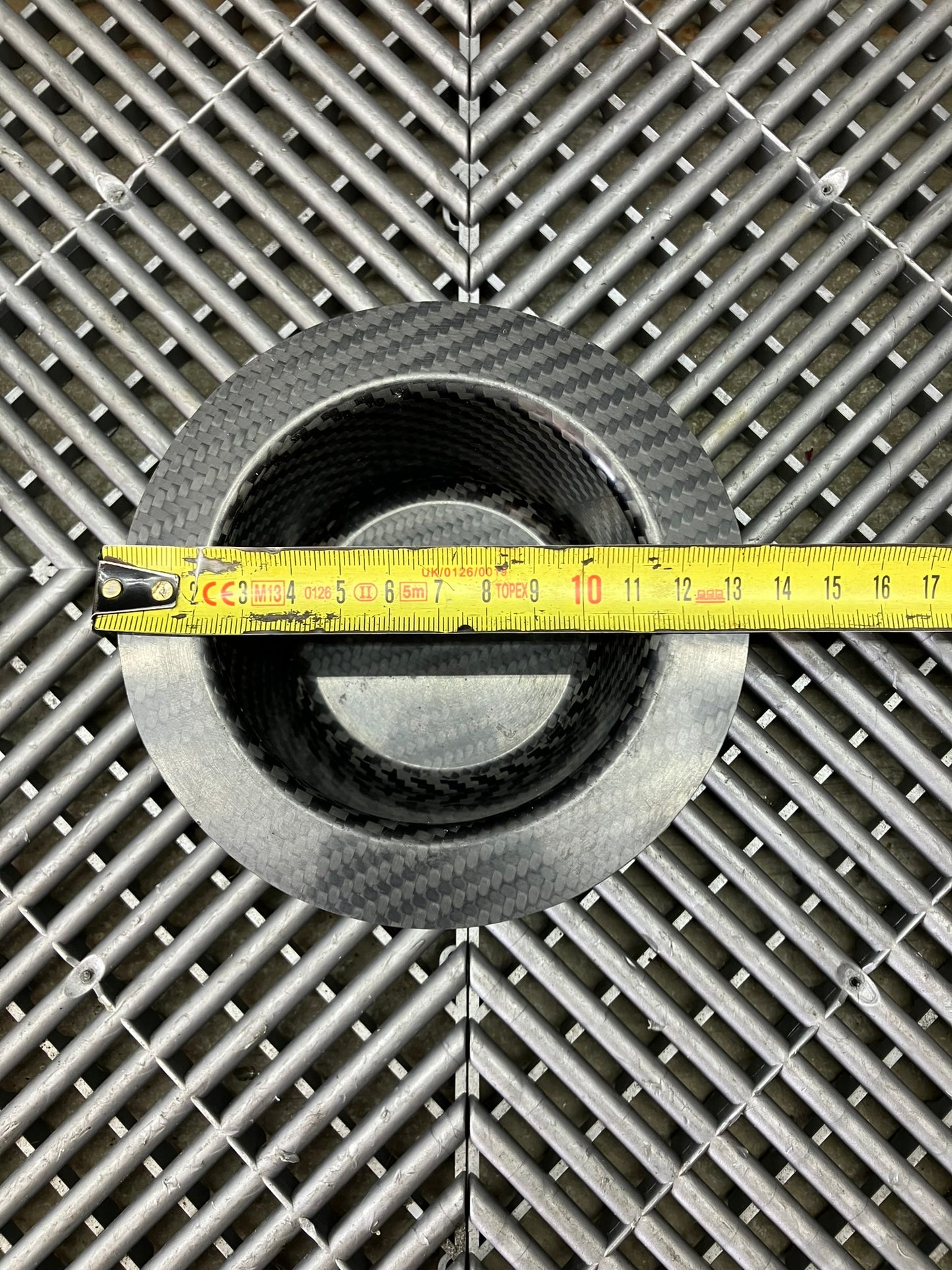 New. Air jack connecting valve mounting bracket. Carbon fiber.