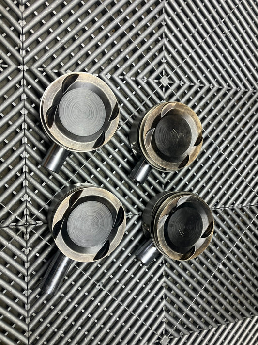 Used. Escort-Sierra Cosworth engine Mahle pistons.