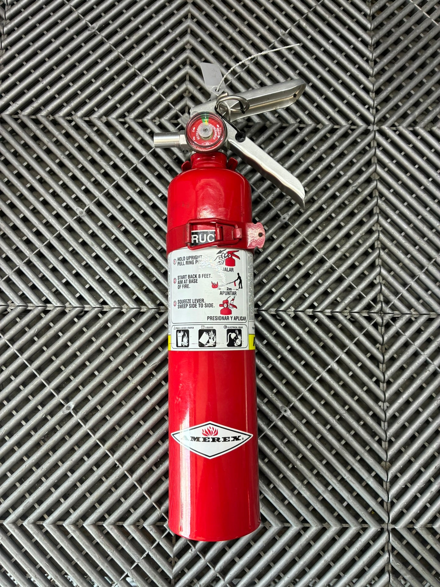 Used. Never released. Hand Fire extinguisher. Metal mounting plate.