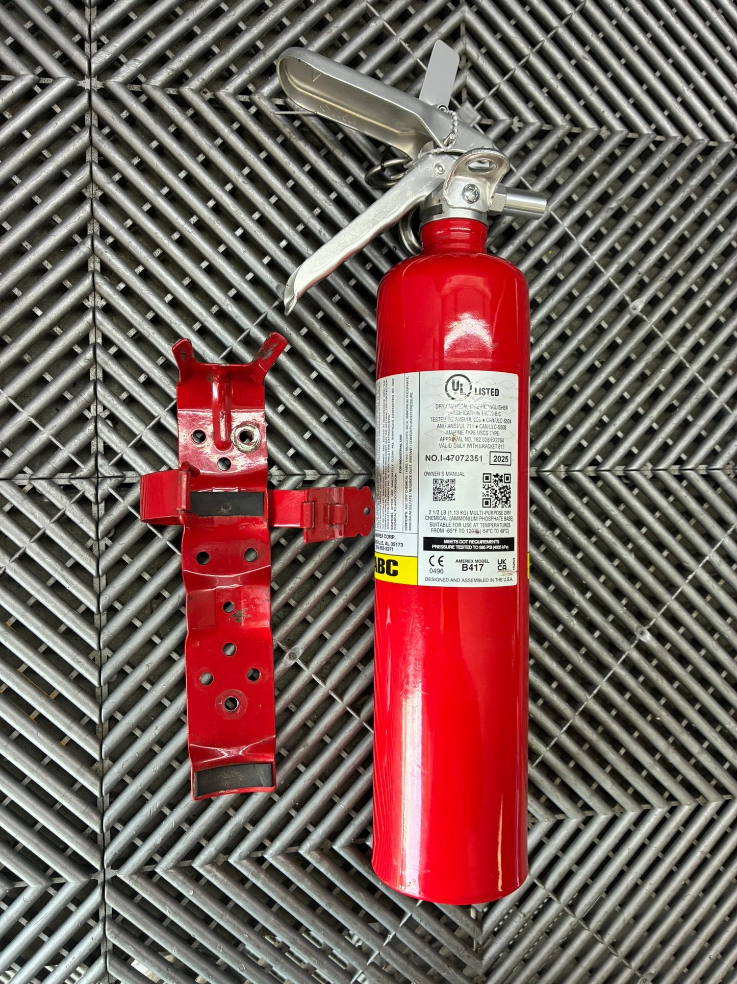 Used. Never released. Hand Fire extinguisher. Metal mounting plate.
