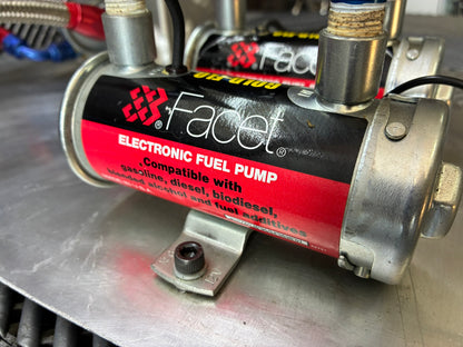 Used. Fuel surge tank and pump assembly mounted on an aluminum baseplate.