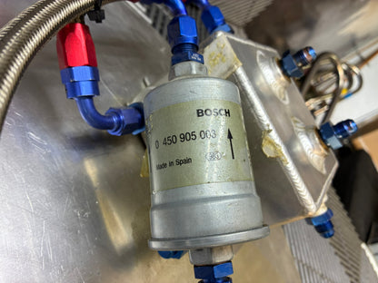 Used. Fuel surge tank and pump assembly mounted on an aluminum baseplate.